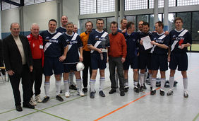 Freuen sich mit über ihren Sieg beim zweiten „HFV-Ü 35-Futsal-Cup“: die Spieler des SV Mörlenbach. Verbandsfußballwart Armin Keller (links) freut sich mit. Foto: Stephanie Nöthen