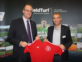 HFV-Präsident Stefan Reuß (li.) und Kai Weber-Gemmel (Field Turf Sales Manager Germany) am Stand der Sportstättenmesse Sportinfra. Foto: HFV